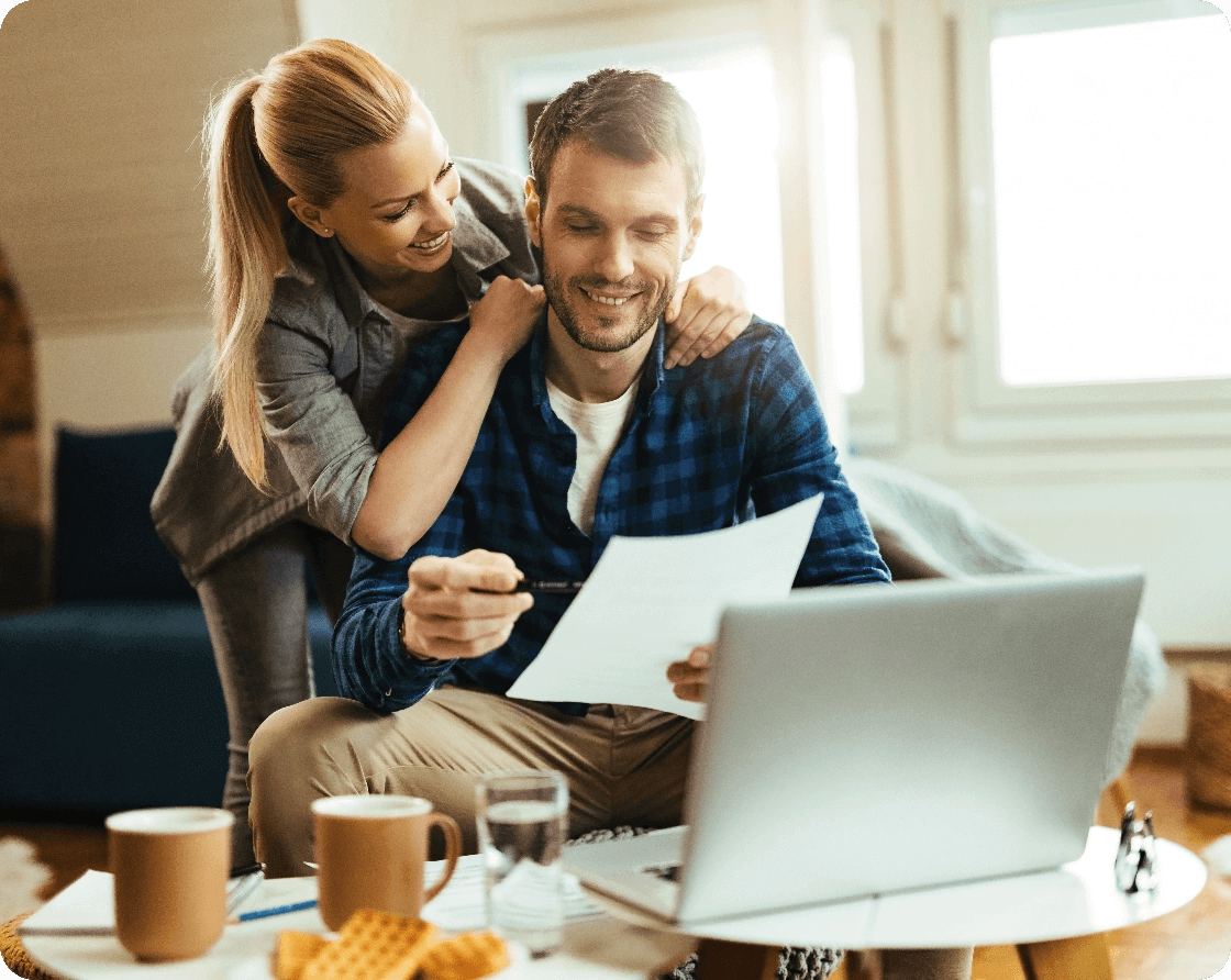 happy-couple-analyzing-their-home-budget-while-paying-bill-computer@2x (1)